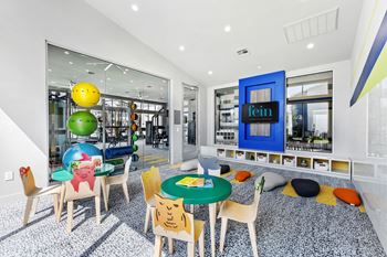 A brightly colored room with a table and chairs.